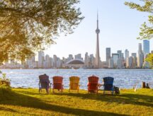 A set of chairs faces the CN Tower on a warm summer day in Ontario.
